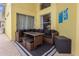 Inviting outdoor patio with dining set and shaded seating area at 217 Holborn Loop, Davenport, FL 33897