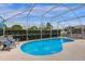 Inviting pool with screened enclosure and comfortable lounge chairs at 217 Holborn Loop, Davenport, FL 33897