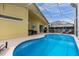 Inviting screened-in pool area with blue water and ample seating perfect for relaxation and entertainment at 217 Holborn Loop, Davenport, FL 33897