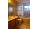 Bathroom with a combination tub and shower setup, featuring an owl-themed shower curtain at 225 Vista Dr, Davenport, FL 33897