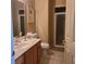 Clean bathroom with a glass-enclosed shower, vanity with sink, and neutral tile flooring at 225 Vista Dr, Davenport, FL 33897