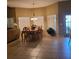Spacious dining room with a large wooden table, decorative chandelier, and tile flooring at 225 Vista Dr, Davenport, FL 33897