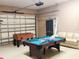 Finished garage features a pool table, foosball, and comfortable seating area at 225 Vista Dr, Davenport, FL 33897