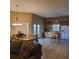 Eat-in kitchen with tile flooring, oak cabinets, white appliances, and an adjacent dining area at 225 Vista Dr, Davenport, FL 33897