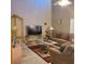 Comfortable living room with plush sofas, area rug, tall ceilings, and ample natural light at 225 Vista Dr, Davenport, FL 33897
