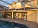 Back patio with pool, outdoor furniture, grill and covered patio at 225 Vista Dr, Davenport, FL 33897