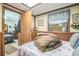 Bedroom showcasing a skylight, wood paneling, and patterned bedding at 24089 Ne 152Nd Ln, Fort Mc Coy, FL 32134