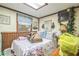 Bedroom with skylight, wood paneling, and floral bedding at 24089 Ne 152Nd Ln, Fort Mc Coy, FL 32134