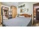 Bedroom features a wood bed frame, wood paneled closet, and decor at 24089 Ne 152Nd Ln, Fort Mc Coy, FL 32134