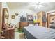Bedroom featuring a bed, dresser, television, and wood paneled accent wall at 24089 Ne 152Nd Ln, Fort Mc Coy, FL 32134