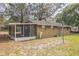 Rear exterior view showing the screened porch and the home's neutral toned siding at 24089 Ne 152Nd Ln, Fort Mc Coy, FL 32134