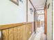 Hallway with wood paneling and bi-fold doors at 24089 Ne 152Nd Ln, Fort Mc Coy, FL 32134