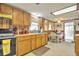 Well-lit kitchen with wood cabinets, a black oven, and a dining table at 24089 Ne 152Nd Ln, Fort Mc Coy, FL 32134