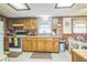 Charming kitchen featuring wood cabinets, a window over the sink, and a dining area at 24089 Ne 152Nd Ln, Fort Mc Coy, FL 32134