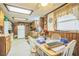 Eat-in kitchen area with a ceiling fan, appliances, and dining area for Gathering meals at 24089 Ne 152Nd Ln, Fort Mc Coy, FL 32134