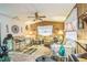 Cozy living room featuring wood paneling, comfortable seating, and a ceiling fan at 24089 Ne 152Nd Ln, Fort Mc Coy, FL 32134