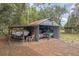 Exterior shot of outbuilding with boat and supplies on property at 24089 Ne 152Nd Ln, Fort Mc Coy, FL 32134