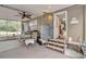 Covered patio with fan, steps, windows, table and chairs, and an outdoor view at 24089 Ne 152Nd Ln, Fort Mc Coy, FL 32134