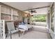 Covered patio with fan, windows, table and chairs, and an outdoor view at 24089 Ne 152Nd Ln, Fort Mc Coy, FL 32134