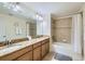 Bathroom featuring a shower, a bath and a double sink vanity with granite countertops at 3055 Beach Palm Ave, Kissimmee, FL 34747