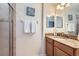 Well-lit bathroom with granite counter, shower with glass door, and towel rack at 3055 Beach Palm Ave, Kissimmee, FL 34747