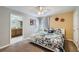 Comfortable bedroom with patterned bedding, ceiling fan, and ensuite bathroom access at 3055 Beach Palm Ave, Kissimmee, FL 34747