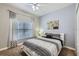 Modern bedroom with soft carpet, ceiling fan, and a well-lit window at 3055 Beach Palm Ave, Kissimmee, FL 34747