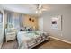 Cozy bedroom featuring a ceiling fan, neutral color palette and comfortable bed at 3055 Beach Palm Ave, Kissimmee, FL 34747