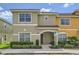 Inviting two-story townhome with a tile roof, manicured landscaping, and an accessible entrance at 3055 Beach Palm Ave, Kissimmee, FL 34747
