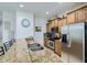 Stylish kitchen with stainless steel appliances, granite counters, and a breakfast bar with seating at 3055 Beach Palm Ave, Kissimmee, FL 34747