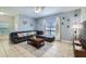 Comfortable living room with tile flooring, neutral walls, and a cozy seating area with decorative pillows at 3055 Beach Palm Ave, Kissimmee, FL 34747