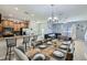 Open concept living area with a kitchen bar, tile flooring, and a dining and Gathering room combo at 3055 Beach Palm Ave, Kissimmee, FL 34747