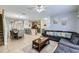 Inviting living space featuring tile floors, a cozy seating area, and a breakfast bar with kitchen view at 3055 Beach Palm Ave, Kissimmee, FL 34747