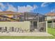 Screened-in patio with seating and lush lawn at 3055 Beach Palm Ave, Kissimmee, FL 34747