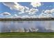 Scenic view of the community pond and neighboring townhomes at 3055 Beach Palm Ave, Kissimmee, FL 34747
