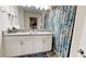 Charming bathroom featuring double sinks, granite countertop, and a decorative shower curtain at 3083 Tom Sawyer Dr, Kissimmee, FL 34746