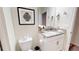 Cozy bathroom featuring modern fixtures, granite countertop, and a framed decorative art piece at 3083 Tom Sawyer Dr, Kissimmee, FL 34746