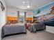 Vibrant bedroom featuring two twin beds and a colorful, animated airplane mural on the wall at 3083 Tom Sawyer Dr, Kissimmee, FL 34746