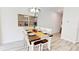 Elegant dining room featuring a wooden table, chandelier, mirrors, and stylish decor at 3083 Tom Sawyer Dr, Kissimmee, FL 34746