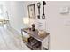 Hallway with decorative console table, stylish lamp, and modern wall decor at 3083 Tom Sawyer Dr, Kissimmee, FL 34746