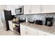 Well-equipped kitchen with granite countertops, stainless steel appliances, and ample cabinet space at 3083 Tom Sawyer Dr, Kissimmee, FL 34746