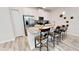 Modern kitchen with a granite island, stainless steel appliances, and counter seating at 3083 Tom Sawyer Dr, Kissimmee, FL 34746