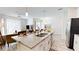 Kitchen with island, stainless steel appliances, granite countertops, and open layout at 3083 Tom Sawyer Dr, Kissimmee, FL 34746