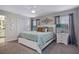 Main bedroom showcasing neutral tones, large windows, and ensuite bathroom at 3083 Tom Sawyer Dr, Kissimmee, FL 34746