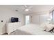 Neutral main bedroom with a ceiling fan, dresser, and relaxing decor at 3083 Tom Sawyer Dr, Kissimmee, FL 34746