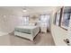 Spacious main bedroom featuring a queen-size bed, ceiling fan, and decorative accents at 3083 Tom Sawyer Dr, Kissimmee, FL 34746