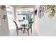 Inviting covered patio with dining table and a view of a private pool at 3083 Tom Sawyer Dr, Kissimmee, FL 34746