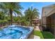 Secluded backyard oasis featuring a hot tub, hammock, and tropical landscaping, perfect for relaxation and outdoor living at 3188 Verbena Ct, Deltona, FL 32725