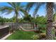 Lush backyard featuring a hammock, palm trees, a jacuzzi, and tropical landscaping at 3188 Verbena Ct, Deltona, FL 32725