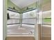Bright bathroom featuring a large garden tub with tile surround and a glass-enclosed shower at 3188 Verbena Ct, Deltona, FL 32725